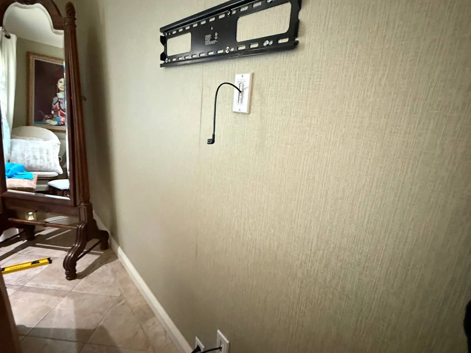 TV wall mount with concealed wiring — pre-wire result at trim stage