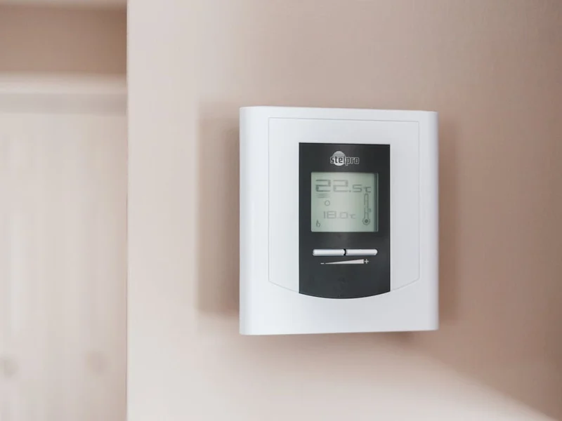 Smart thermostat mounted on a residential interior wall
