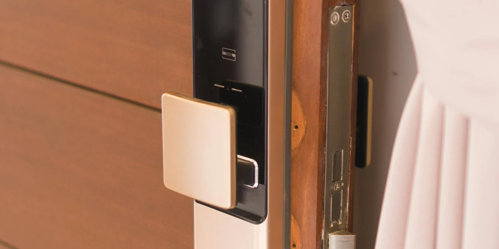 Smart deadbolt with fingerprint reader installed on a wooden door