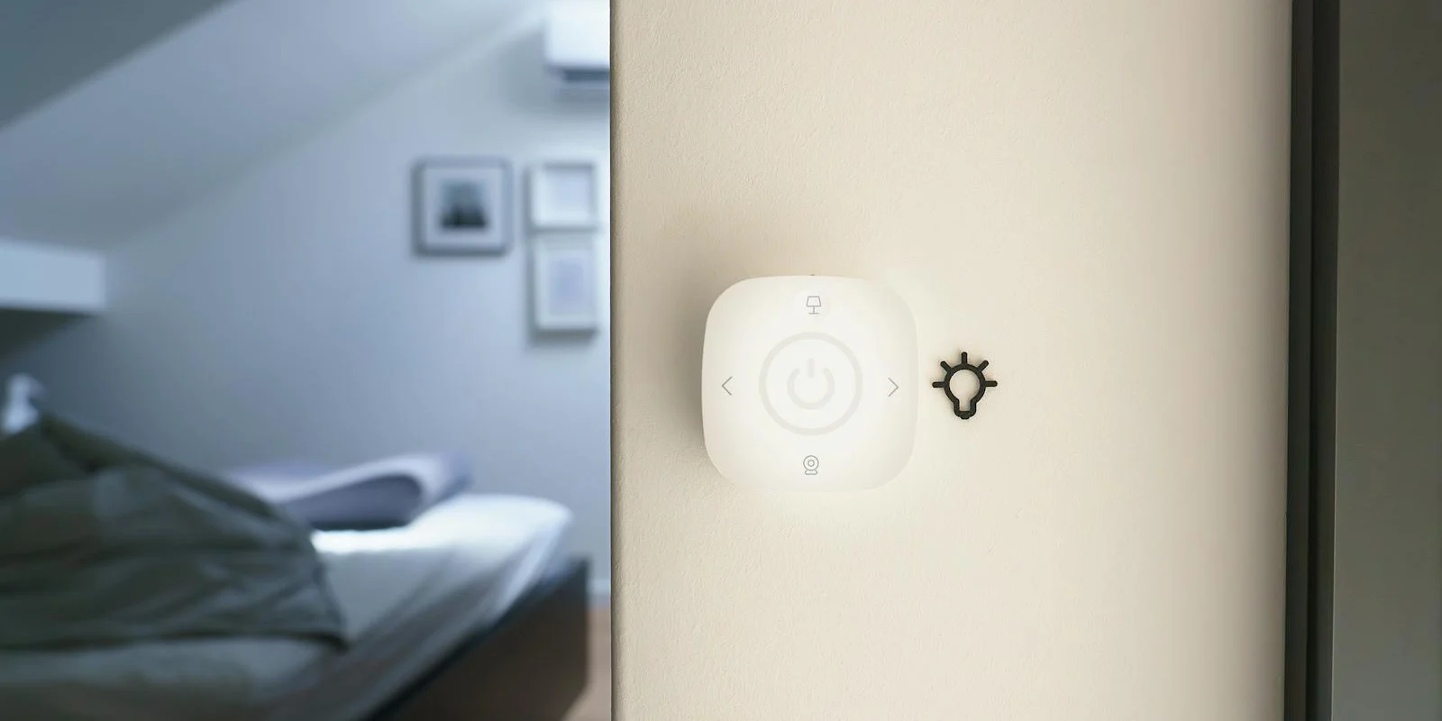 Lutron Caseta-style smart lighting controller mounted on a modern bedroom wall