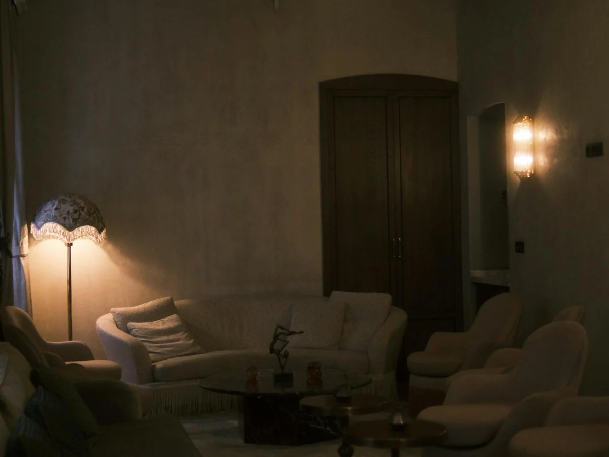 Warm-dimmed living room scene with single accent lamp glow